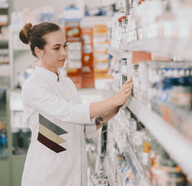 medicine-pharmaceutics-health-care-people-concept-female-pharmacist-taking-medications-from-shelf-min